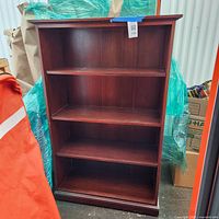Front view of four-shelf dark wood bookcase