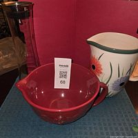 All three items grouped: clear beverage pitcher, red handled bowl, floral ceramic pitcher