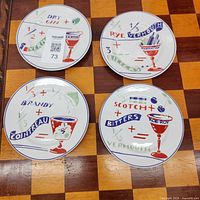 Top view of four illustrated cocktail recipe plates