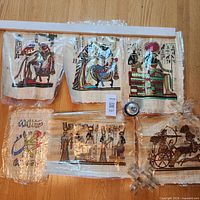 All six papyrus prints sealed in plastic shown together