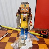 Full view of hippie nutcracker on chessboard surface