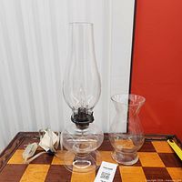 Hurricane lamp with chimney and vase side by side