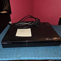 Front view of Insignia DVD player on mat
