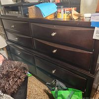 Full front view of dresser showing eight drawers and silver-tone knobs