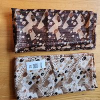 Both scarves folded showing pattern and texture