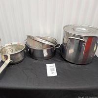 Full view of stock pot with lid, medium pot with insert, food mill