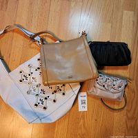 Four handbags displayed front view