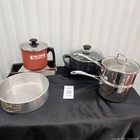 Group shot of saucepan, steamer, electric fondue pot, springform pan