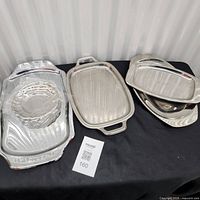 All six silver-tone trays arranged on table