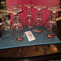 Seven Stella Artois glasses upside down on cloth