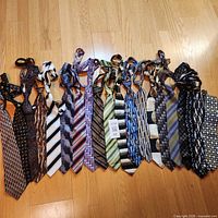 Full set of 20 pre-tied ties laid flat showing patterns