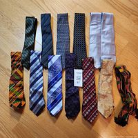 All thirteen ties laid flat showing full variety
