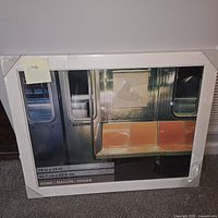 Front view of white frame with subway placeholder print and size information