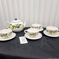 Full view of teapot, four teacups on saucers