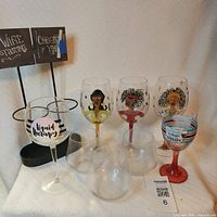 Group shot showing all five stemmed glasses, three stemless glasses, and metal wine stand with chalkboards