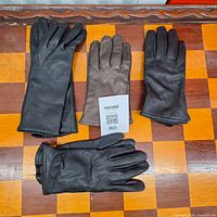 Four pairs leather gloves on chessboard surface