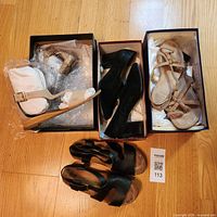 All four pairs of shoes in boxes and on floor