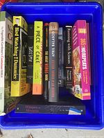 Top view of all ten books standing in blue crate