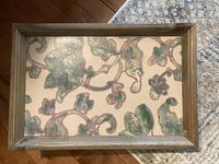 Top view of wooden tray showing foliage design surface