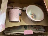 Boxed set showing cup, spoon, bowl inside packaging