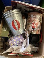 Box view showing galvanized O tin, Santa mug, assorted items