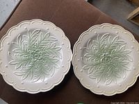 Front view of both cream plates with mint leaf pattern