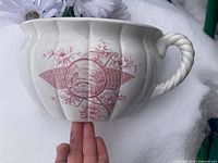 Full view of chamber pot exterior showing pink design and handle