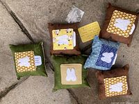 All six handmade pillows, plastic pouch and note card shown together