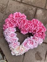 Front view of heart wreath showing gradient pink to white artificial roses