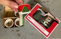 Open box showing four napkin rings and boxed salt & pepper shakers