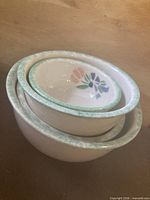 Stacked view of four nesting Pentik stoneware bowls