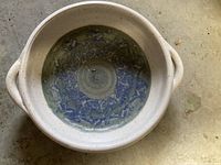 Top view of the shallow stoneware bowl showing interior glaze and side handles