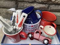 Group shot of all mugs, cheese spreaders inside mug, and pickup truck ornament
