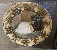 Front view showing full mirror with gold metal floral frame