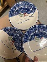 Three plates displayed showing full snowman design and speckled rim