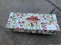 Closed floral print box marked Nakery Beauty