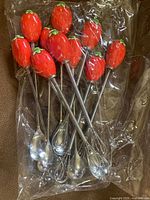 utensils in original plastic bag showing strawberry handles, spoon bowls and whisk heads