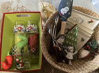Overall lot showing tumblers, pepper shakers, spatula, carving forks, plates and ornaments in basket