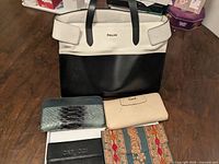 Front view of Pollini tote with four wallets displayed