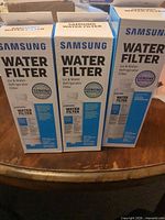 Front view of three sealed Samsung refrigerator water filter boxes