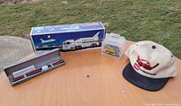 Group view: Hess boxed truck & shuttle, New Holland die-cast, Toro cap, wristwatch in case
