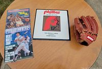 All three items on round table: Sports Illustrated magazine, Phillies LP, Regent glove exterior