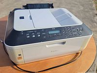 Front view of Canon Pixma MX320 showing control panel and output tray