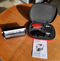 Full lot: laser level kit in case, tactical pen multitool box, instruction manual