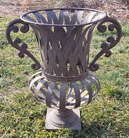 Full view of urn planter showing lattice body, handles, and base