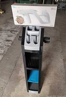 Boxed Wii Zapper placed atop Guitar Hero stand