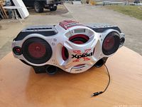 Front view of Sony Xplod boombox showing speakers, branding and attached power cord