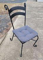front angle of wrought iron chair with cushion attached
