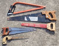 All five saws laid out on concrete surface