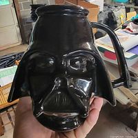 Front view showing Darth Vader face sculpt and handle